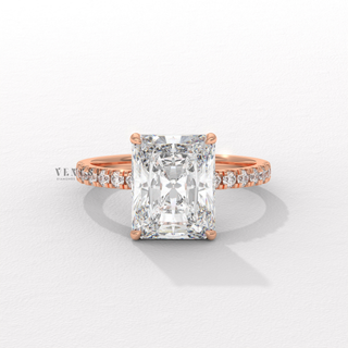 Side profile of a radiant cut moissanite engagement ring with a hidden halo and pave band