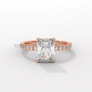 Radiant cut moissanite engagement ring with a hidden halo and pave band shown on a finger