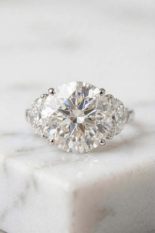Round brilliant three stone moissanite engagement ring side view