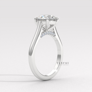 Lifestyle photo of a round cut moissanite engagement ring with a hidden halo and cathedral setting on the hand