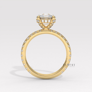 Angled view of a round cut moissanite engagement ring with a hidden halo and pave band catching the light