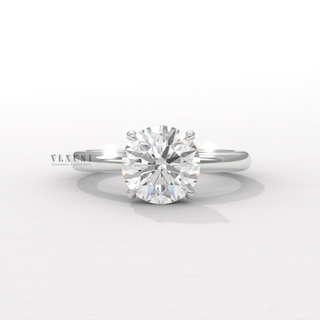 Round cut moissanite engagement ring in a solitaire setting worn on a hand
