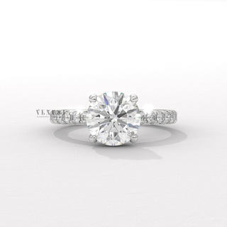 Side profile of a round cut moissanite engagement ring with a hidden halo and pave band