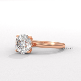 Angled view of a round cut moissanite engagement ring in a solitaire setting catching the light