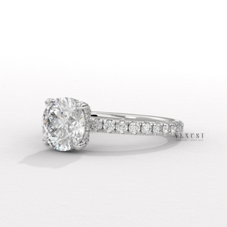 Three-quarter angle of a round cut moissanite engagement ring with a hidden halo and pave band
