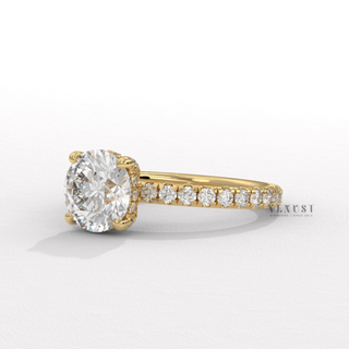 Top-down view of a round cut moissanite engagement ring with a hidden halo and pave band