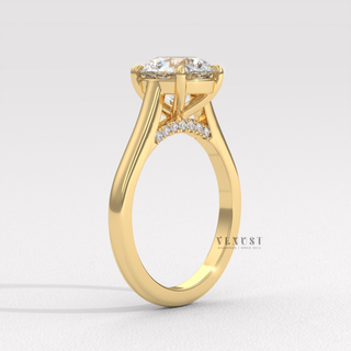 Centre-stone close-up of a round cut moissanite engagement ring with a hidden halo and cathedral setting