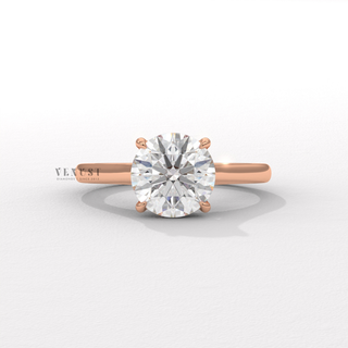 Overhead close-up of a round cut moissanite engagement ring with a hidden halo and cathedral setting