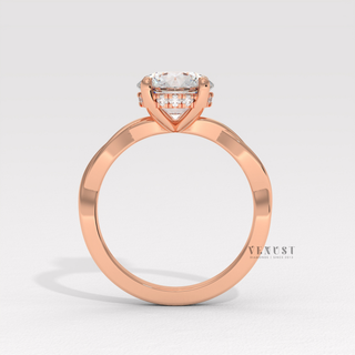 Round cut moissanite engagement ring on an infinity band photographed on a white background