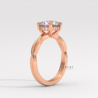 Macro shot of the centre stone on a round cut moissanite engagement ring on an infinity band
