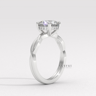 Close-up of a round cut moissanite engagement ring on an infinity band