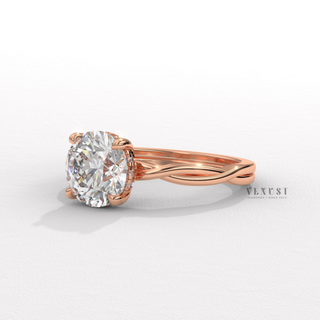Side profile of a round cut moissanite engagement ring on an infinity band