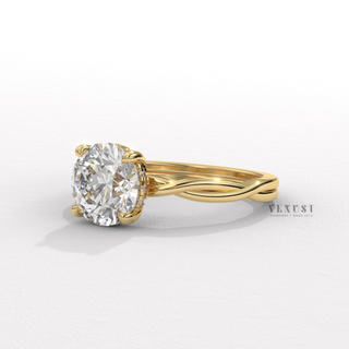 Front view of a round cut moissanite engagement ring on an infinity band