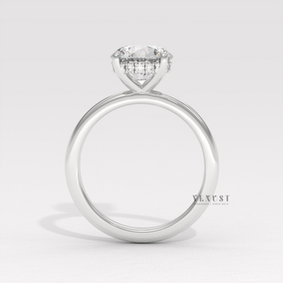 Centre-stone close-up of a round cut moissanite engagement ring in a solitaire setting