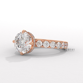 Centre-stone close-up of a round cut moissanite engagement ring with a hidden halo and pave band