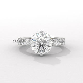 Hand model wearing a round cut moissanite engagement ring with a hidden halo and pave band