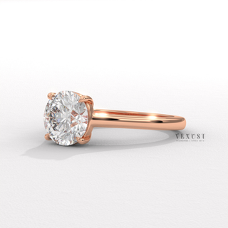 Hand model wearing a round cut moissanite engagement ring with a hidden halo and cathedral setting
