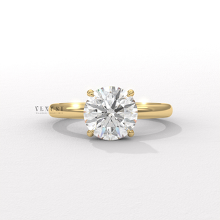 Three-quarter angle of a round cut moissanite engagement ring in a solitaire setting