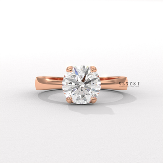 Tilted view of a round cut moissanite engagement ring in a hidden halo solitaire setting showing its sparkle