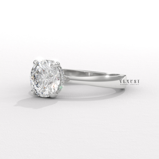 Centre-stone close-up of a round cut moissanite engagement ring in a hidden halo solitaire setting