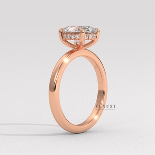 Side profile of a oval cut moissanite engagement ring in a hidden halo solitaire setting from the right