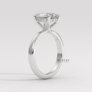 Lifestyle photo of a oval cut moissanite engagement ring in a hidden halo solitaire setting on the hand