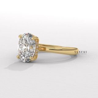 Detailed setting shot of a oval cut moissanite engagement ring in a hidden halo solitaire setting