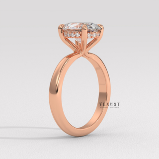 Low-angle view of a oval cut moissanite engagement ring in a hidden halo solitaire setting