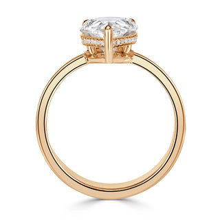 Pear moissanite cigar band engagement ring on hand