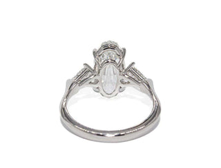 Oval step cut three stone moissanite engagement ring close up detail