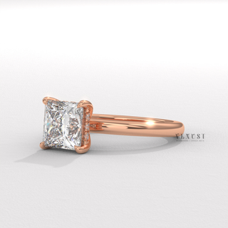 Princess cut moissanite engagement ring in a hidden halo solitaire setting shown on a finger