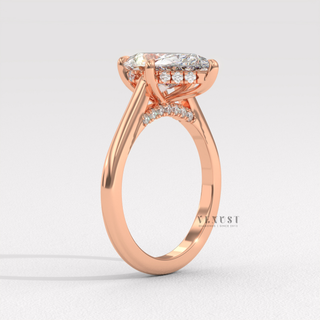 Centre-stone close-up of a pear cut moissanite engagement ring with a hidden halo and cathedral setting