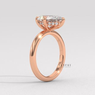 Hand model wearing a pear cut moissanite engagement ring in a hidden halo solitaire setting