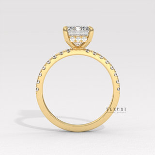 Emerald cut moissanite engagement ring with a hidden halo and pave band shown on a finger