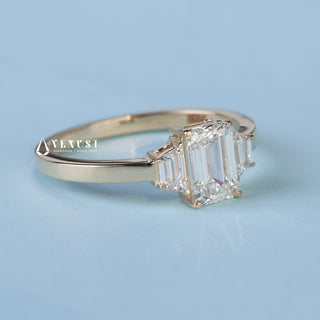 Angled view of Emerald Cut 3 Stone Moissanite Engagement Ring with Accents