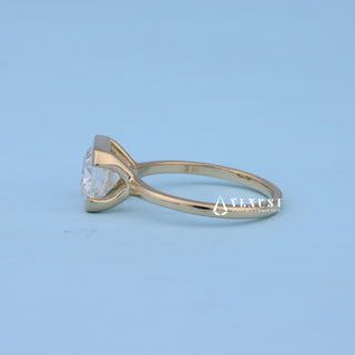Angled view of East West Emerald Cut Bezel Engagement Ring with Moissanite