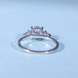 Angled view of Round Cut Moissanite Cluster Engagement Ring with Accents