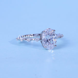 Timeless 1.50ct oval pave moissanite ring shown on a finger