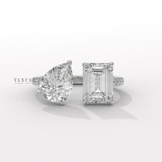 Emerald cut moissanite engagement ring with pear accent