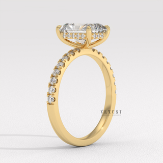 Studio shot of a radiant cut moissanite engagement ring with a hidden halo and pave band on a plain backdrop