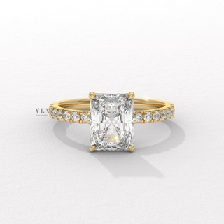 Angled view of a radiant cut moissanite engagement ring with a hidden halo and pave band catching the light