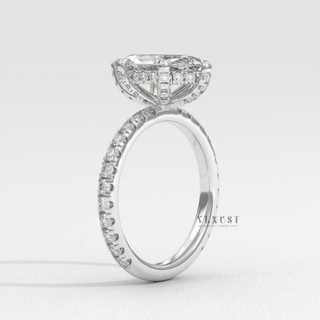 Marquise cut moissanite engagement ring with a hidden halo and pave band worn on a hand