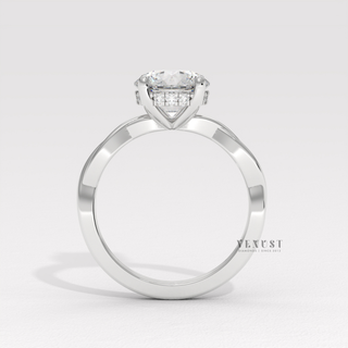 Angled view of a round cut moissanite engagement ring on an infinity band catching the light