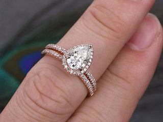 Lustrous 1.0ct pear halo moissanite ring side profile view