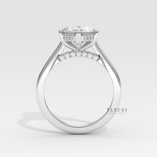 Full view of a pear cut moissanite engagement ring with a hidden halo and cathedral setting with band detail