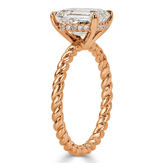 Emerald moissanite braided engagement ring on hand