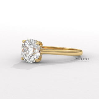 Centre-stone close-up of a round brilliant moissanite engagement ring with a hidden halo and cathedral setting